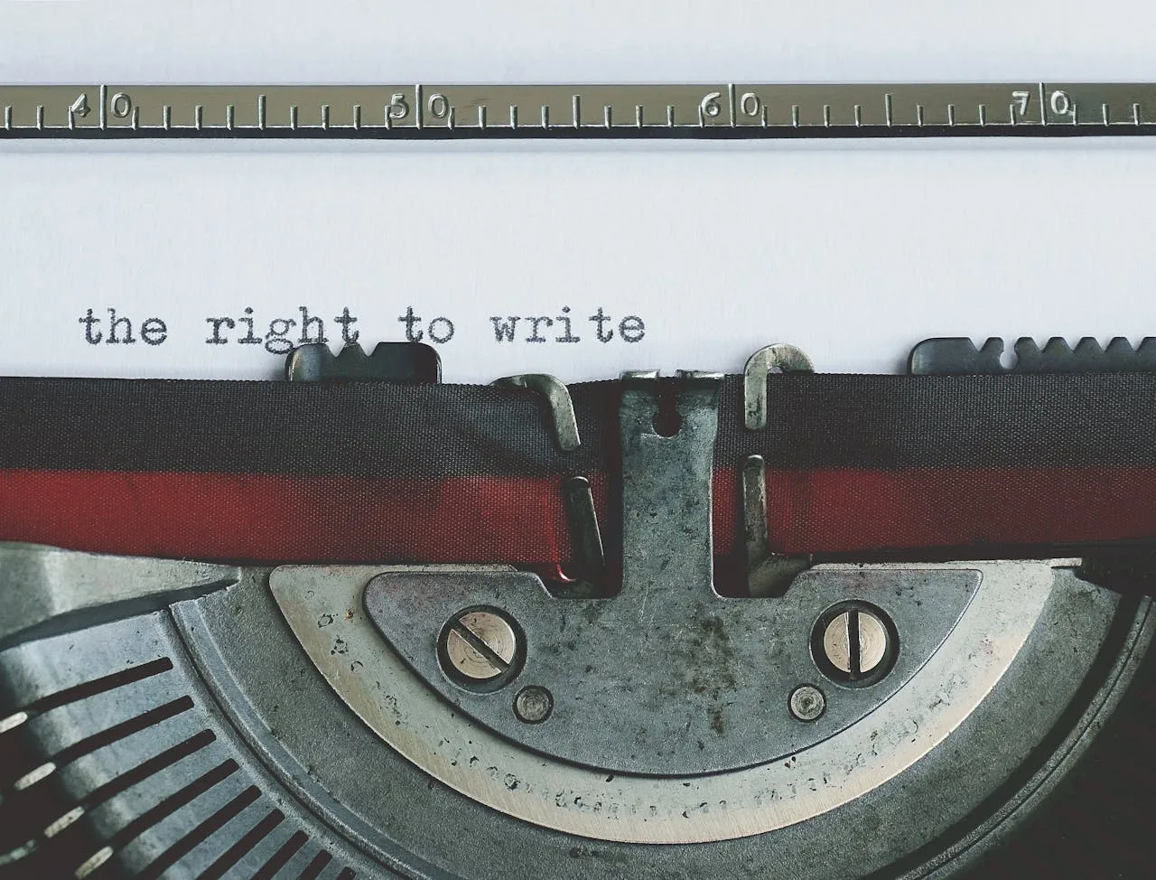 Close-up of a vintage typewriter with 'the right to write' typed on paper.